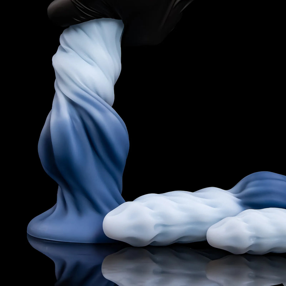 A black-gloved hand twisting Nivaskel's upper shaft while two other forms lie beside it.
