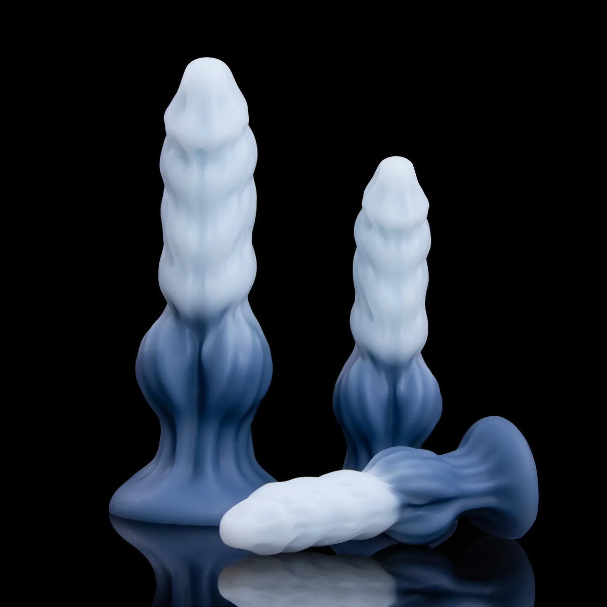 Two upright Nivaskel forms behind a third form lying diagonally, with the blue base at right.